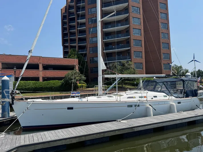 Sanctuary Yacht Photos Pics 2005 Beneteau Oceanis Clipper 473 sailboat docked near a tall building.