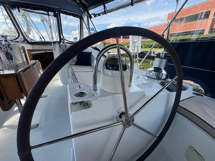 Sanctuary Yacht Photos Pics Steering wheel of 2005 Beneteau Oceanis Clipper 473 sailboat, docked with clear skies.