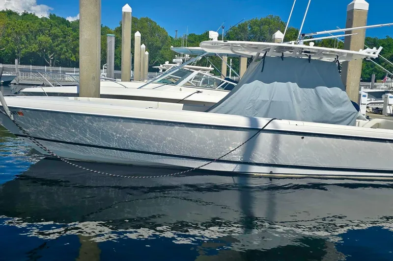  Yacht Photos Pics 2008 Intrepid 323 OPEN boat docked at marina, reflecting on calm water.