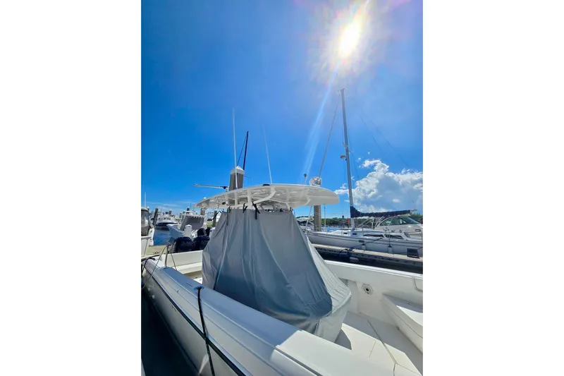  Yacht Photos Pics 2008 Intrepid 323 OPEN boat docked under bright blue sky.