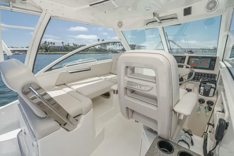 Slingshot Yacht Photos Pics 2018 Boston Whaler 315 Conquest interior with helm, seating, and navigation equipment.