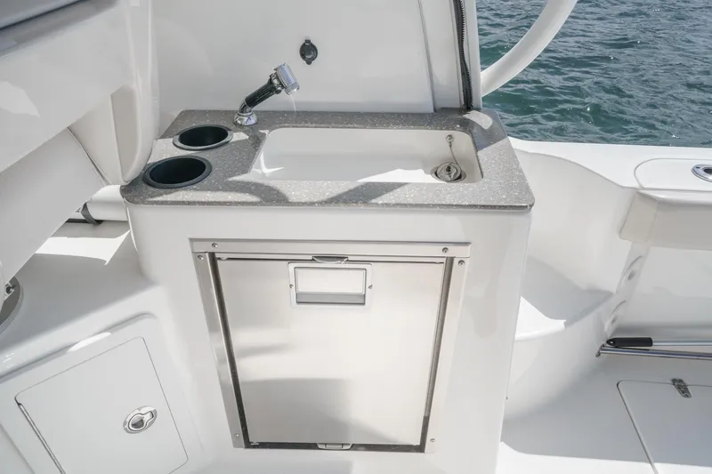 Slingshot Yacht Photos Pics 2018 Boston Whaler 315 Conquest boat sink and storage area by the water.