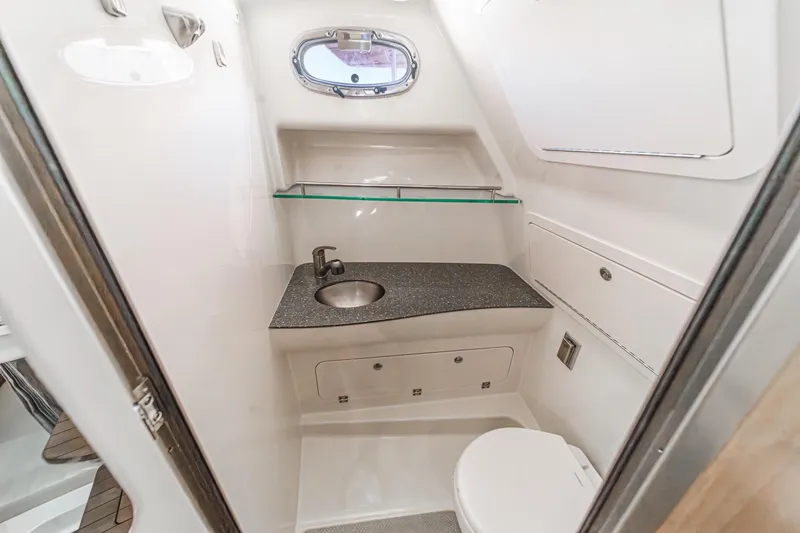 Slingshot Yacht Photos Pics 2018 Boston Whaler 315 Conquest bathroom with sink, toilet, and porthole window.