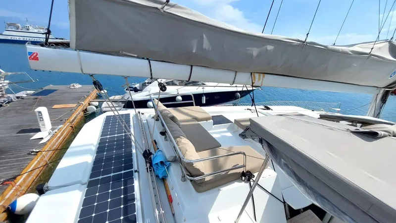  Yacht Photos Pics 2018 Fountaine Pajot Saona 47 catamaran docked, featuring solar panels and spacious deck.