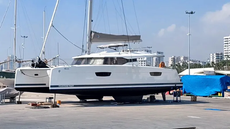  Yacht Photos Pics 2018 Fountaine Pajot Saona 47 catamaran on land, urban background, clear sky.