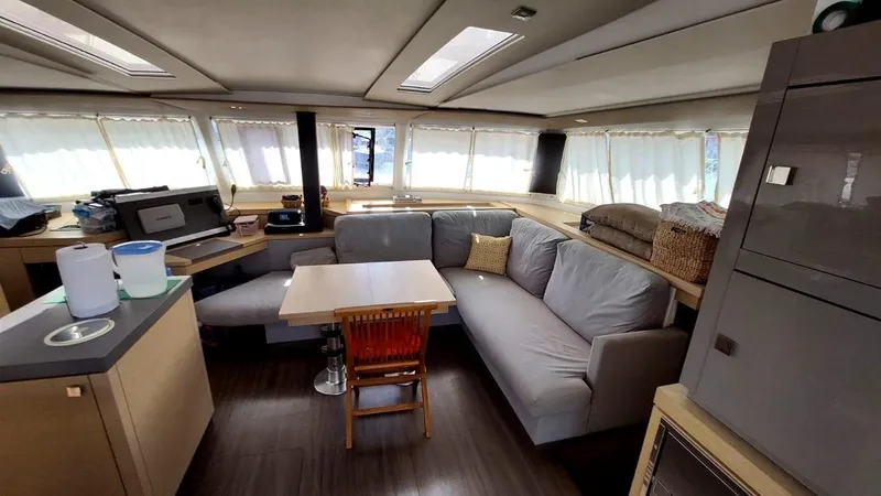  Yacht Photos Pics Interior of 2018 Fountaine Pajot Saona 47 catamaran with modern seating and dining area.