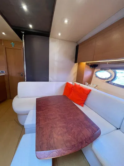  Yacht Photos Pics 2013 Azimut Atlantis 54 yacht interior with wooden table and white seating.