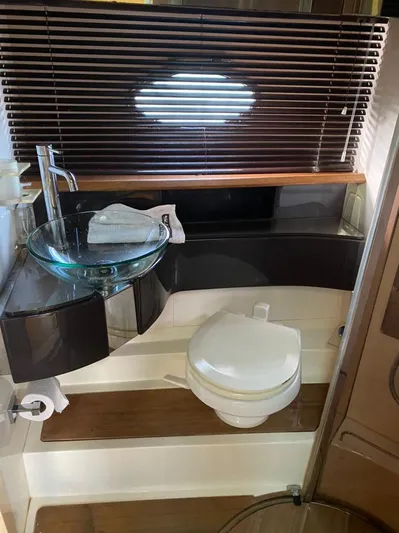  Yacht Photos Pics Modern bathroom in a 2013 Azimut Atlantis 54 yacht with glass sink and wooden accents.