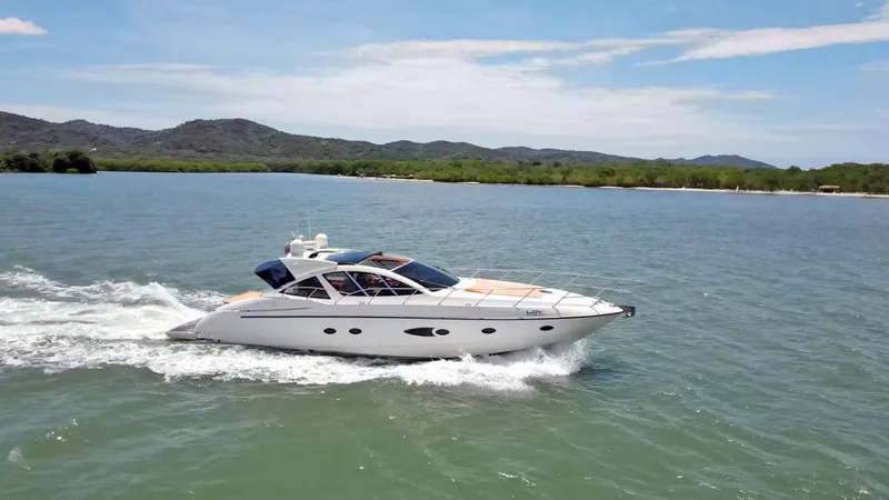  Yacht Photos Pics 2013 Azimut Atlantis 54 yacht cruising on a scenic lake with mountains in the background.