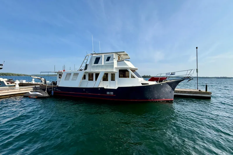  Yacht Photos Pics Custom 60 Trawler, 1994 model, docked on a sunny day with clear blue skies.