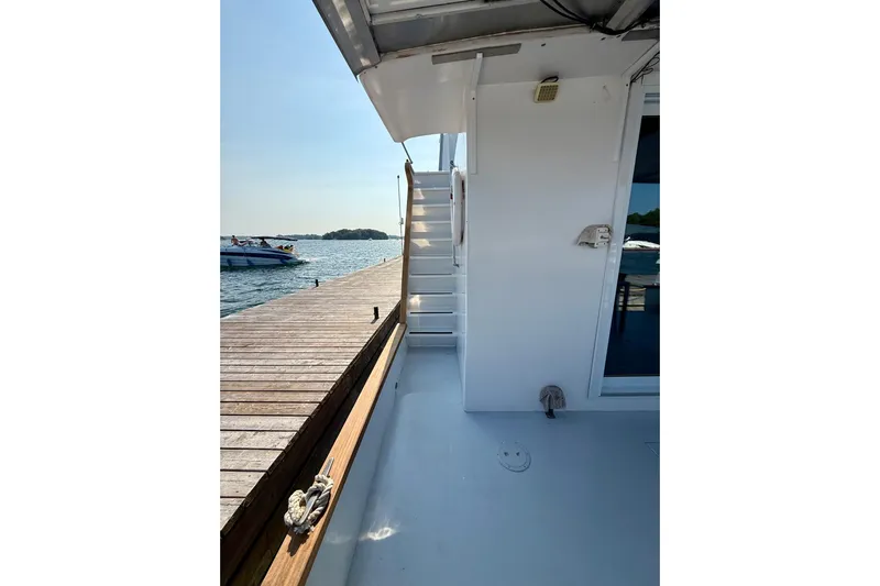  Yacht Photos Pics Custom 60 Trawler 1994 docked, showing deck and stairs under clear sky.