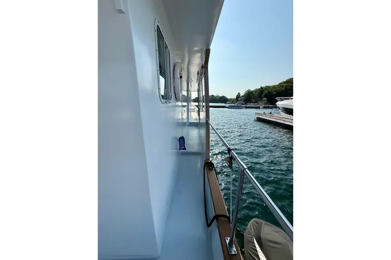  Yacht Photos Pics Side view of a 1994 Custom 60 Trawler docked by the water.