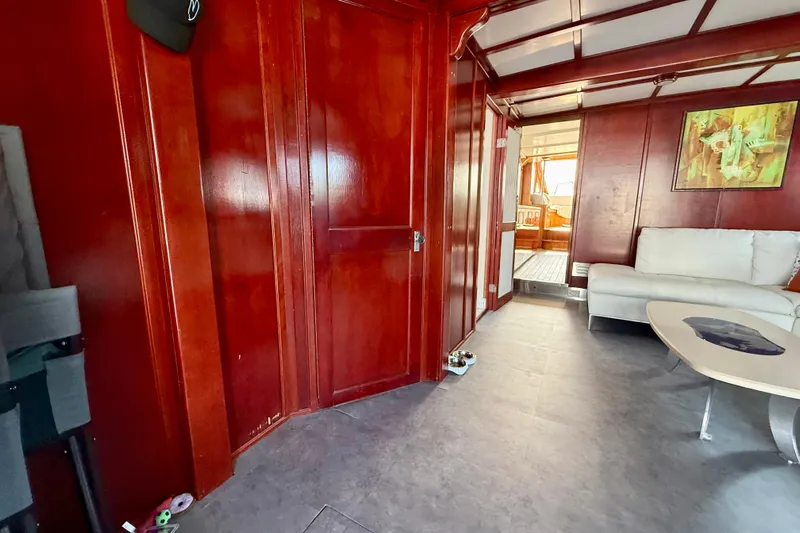  Yacht Photos Pics Interior of 1994 Custom 60 Trawler with wooden walls, white sofa, and modern decor.