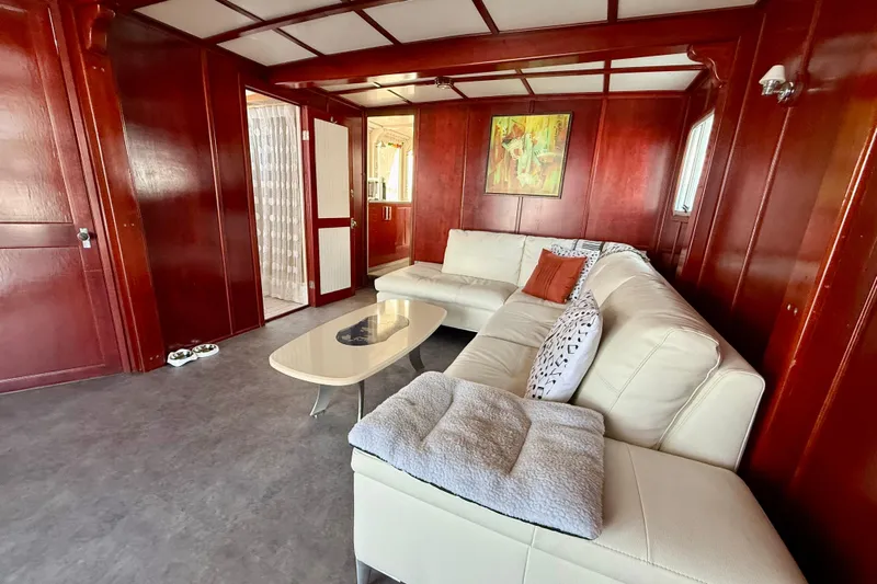  Yacht Photos Pics Luxurious interior of 1994 Custom 60 Trawler with white sofa and wooden paneling.