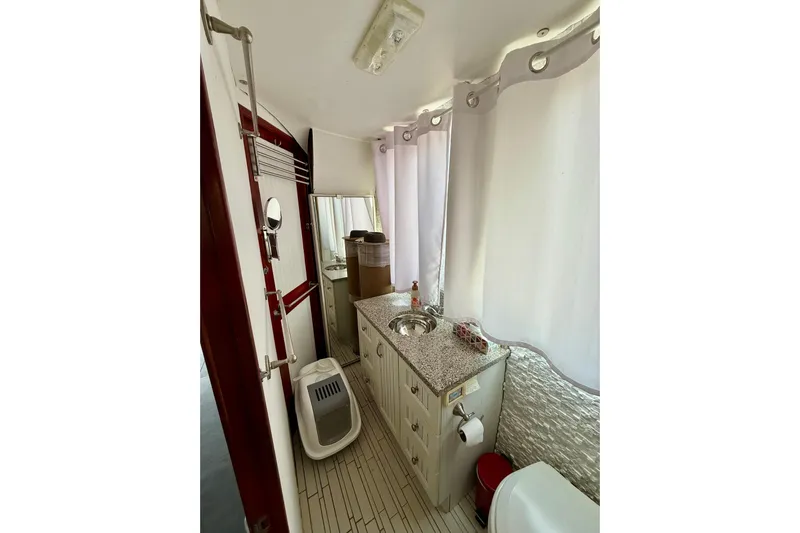  Yacht Photos Pics Bathroom interior of a 1994 Custom 60 Trawler with modern fixtures and white curtains.