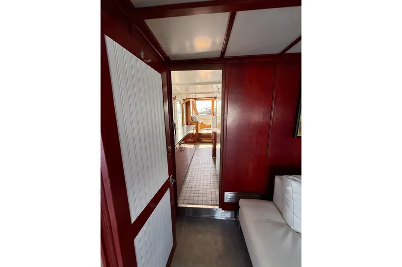  Yacht Photos Pics Interior view of 1994 Custom 60 Trawler with wood paneling and tiled floor.