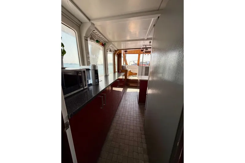  Yacht Photos Pics Interior of 1994 Custom 60 Trawler with modern kitchen and dining area.