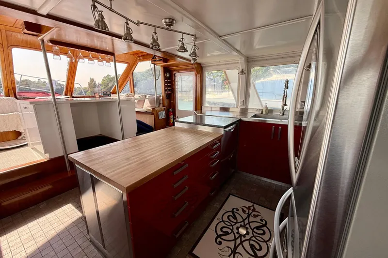  Yacht Photos Pics Interior of 1994 Custom 60 Trawler with modern kitchen and wooden accents.