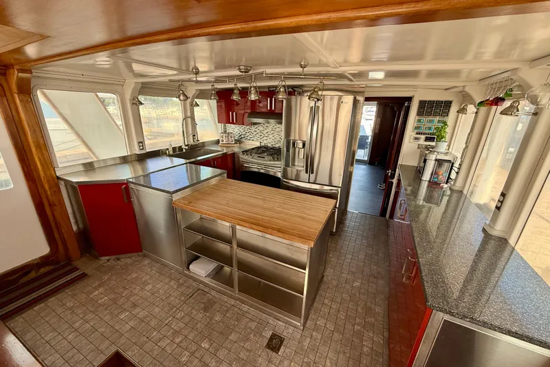  Yacht Photos Pics Luxurious kitchen interior of a 1994 Custom 60 Trawler with modern appliances and wood accents.