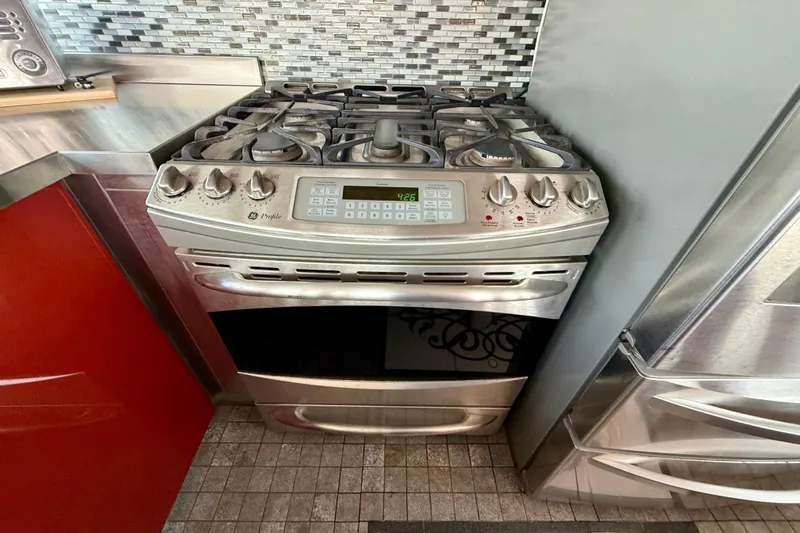  Yacht Photos Pics Stainless steel stove with digital controls in a modern kitchen on a 1994 Custom 60 Trawler.