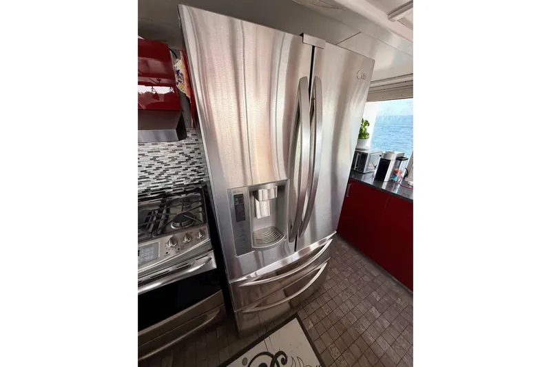  Yacht Photos Pics Stainless steel refrigerator in a modern kitchen on a 1994 Custom 60 Trawler.