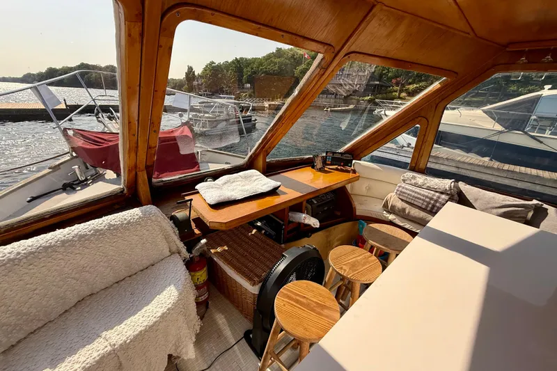  Yacht Photos Pics Cozy interior of a 1994 Custom 60 Trawler with wooden accents and waterfront view.