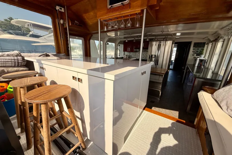 Yacht Photos Pics Interior of 1994 Custom 60 Trawler with modern kitchen and wooden bar stools.