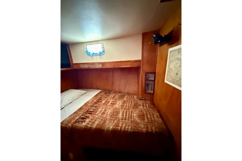  Yacht Photos Pics Cozy cabin interior of 1994 Custom 60 Trawler with bed and porthole window.