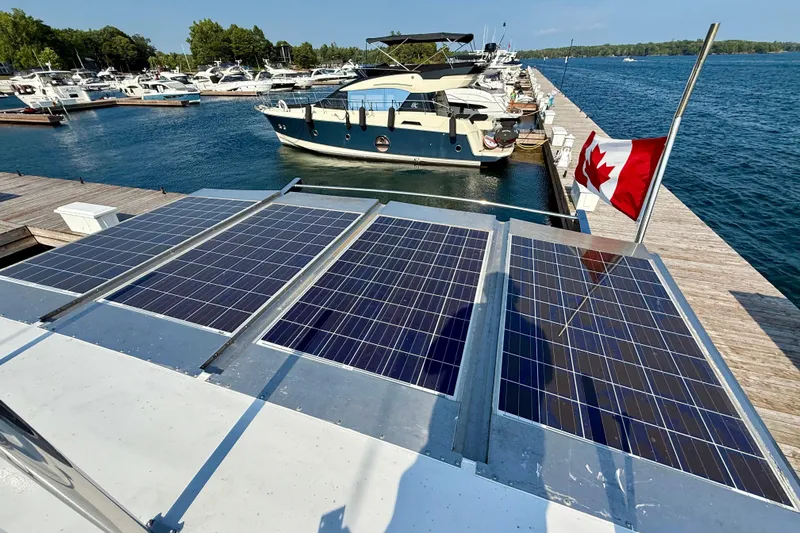  Yacht Photos Pics Solar panels on a 1994 Custom 60 Trawler docked with a Canadian flag.