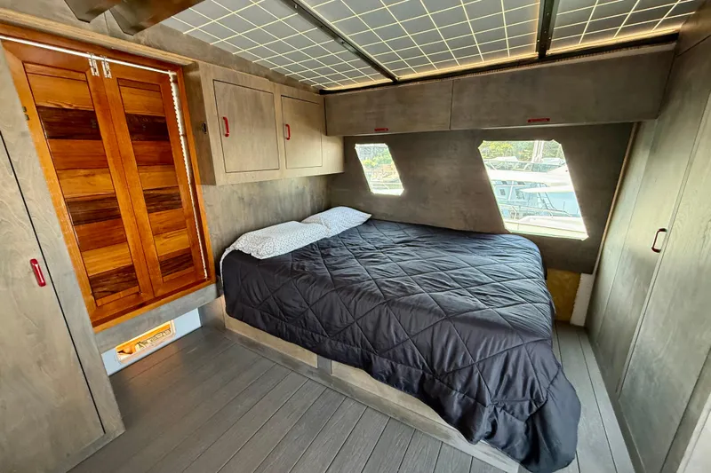  Yacht Photos Pics Cozy bedroom interior of a 1994 Custom 60 Trawler with wooden accents and modern design.