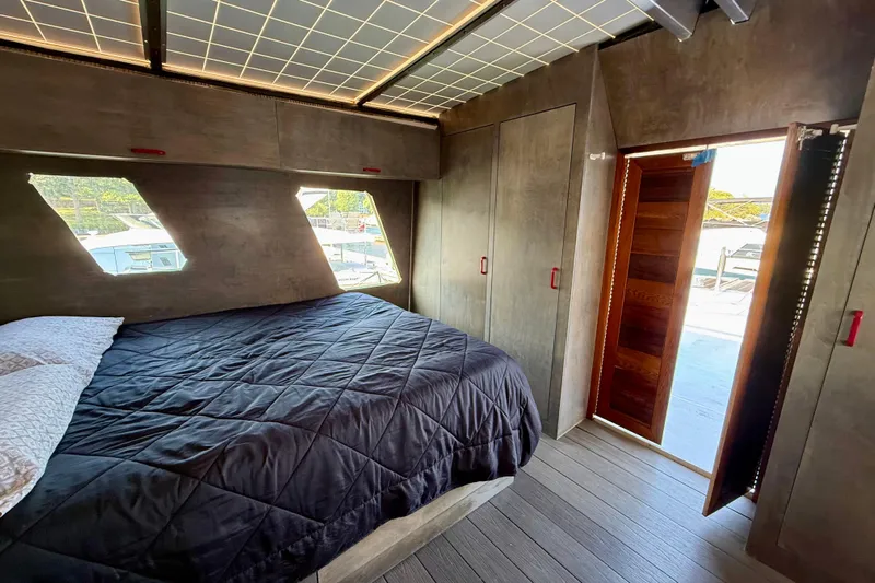  Yacht Photos Pics Luxurious bedroom interior of a 1994 Custom 60 Trawler yacht with modern design.