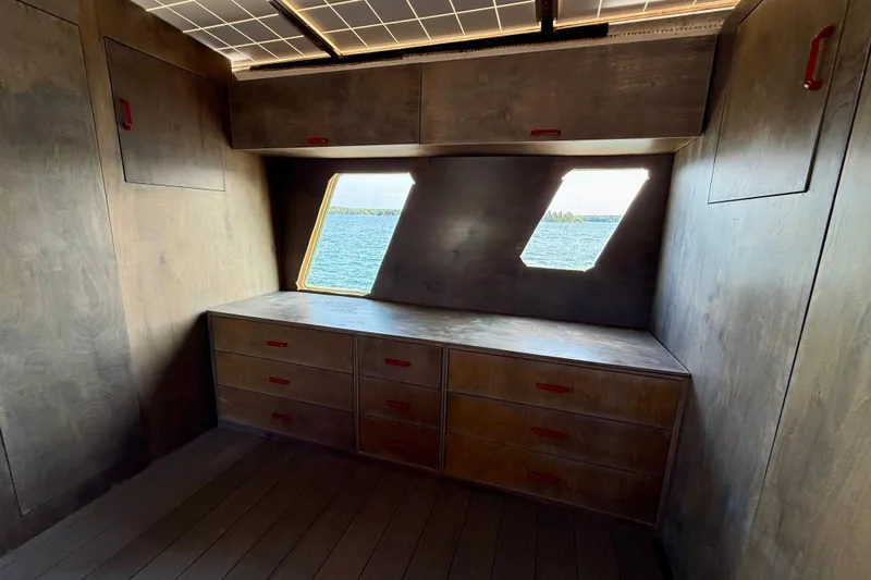  Yacht Photos Pics Interior of a 1994 Custom 60 Trawler with wooden cabinetry and ocean view windows.