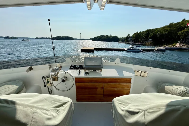  Yacht Photos Pics Helm view from 1994 Custom 60 Trawler, overlooking serene waters and distant shoreline.