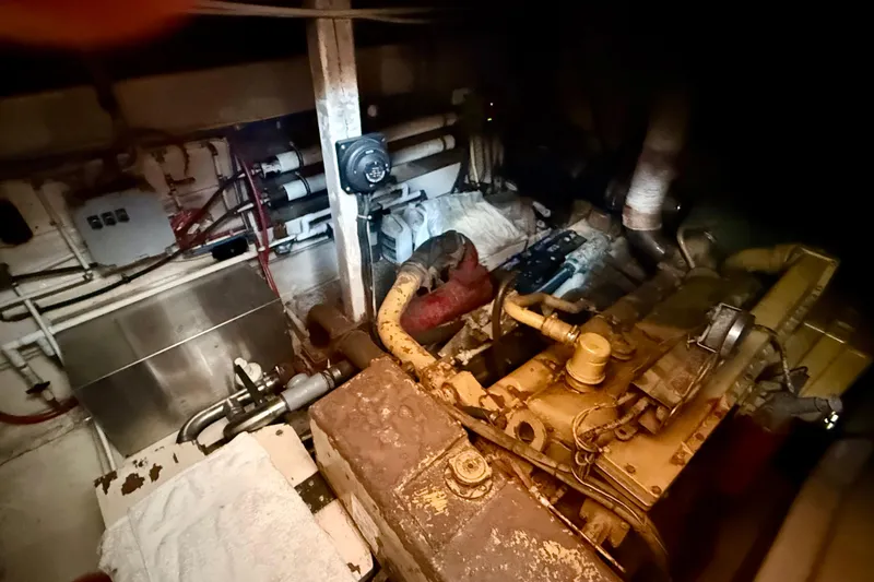  Yacht Photos Pics Engine room of a 1994 Custom 60 Trawler with visible machinery and pipes.