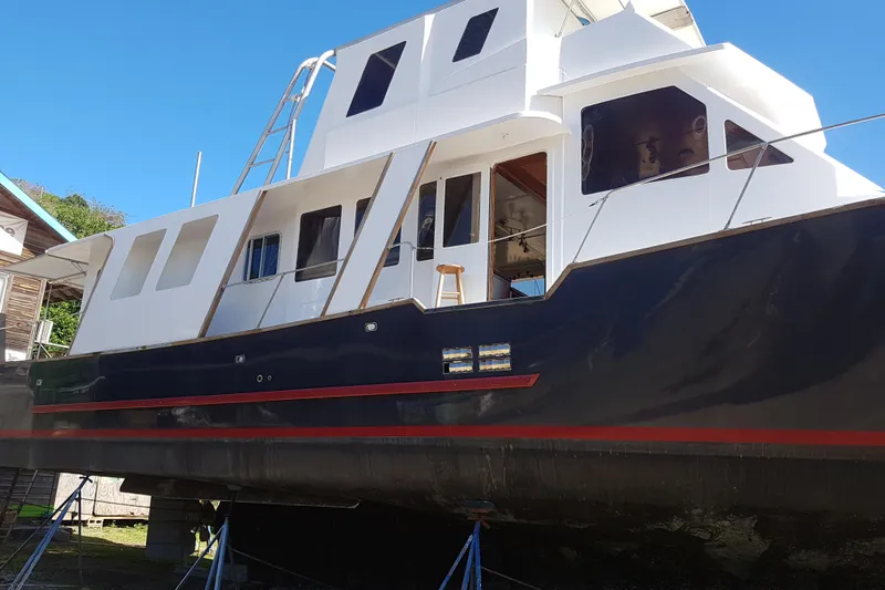  Yacht Photos Pics Custom 1994 60 Trawler yacht on dry dock, featuring a sleek black and white design.