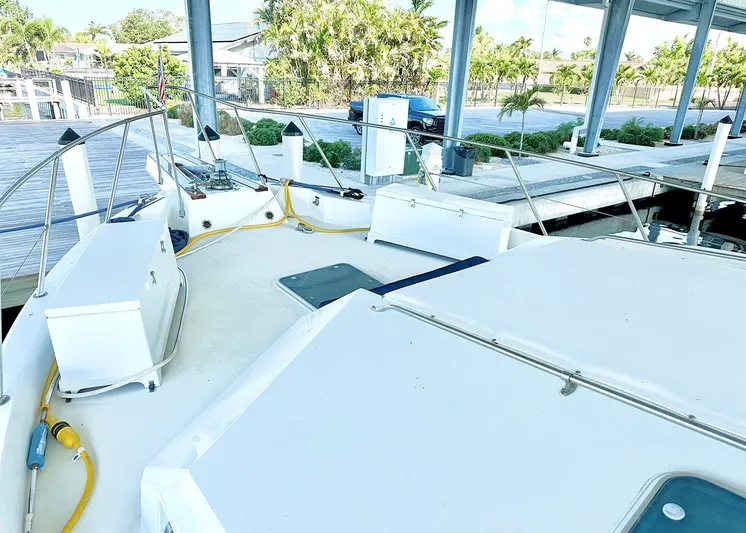 Lumber Away IV Yacht Photos Pics 1994 Hatteras Cockpit Motoryacht docked, showcasing spacious deck and marina surroundings.