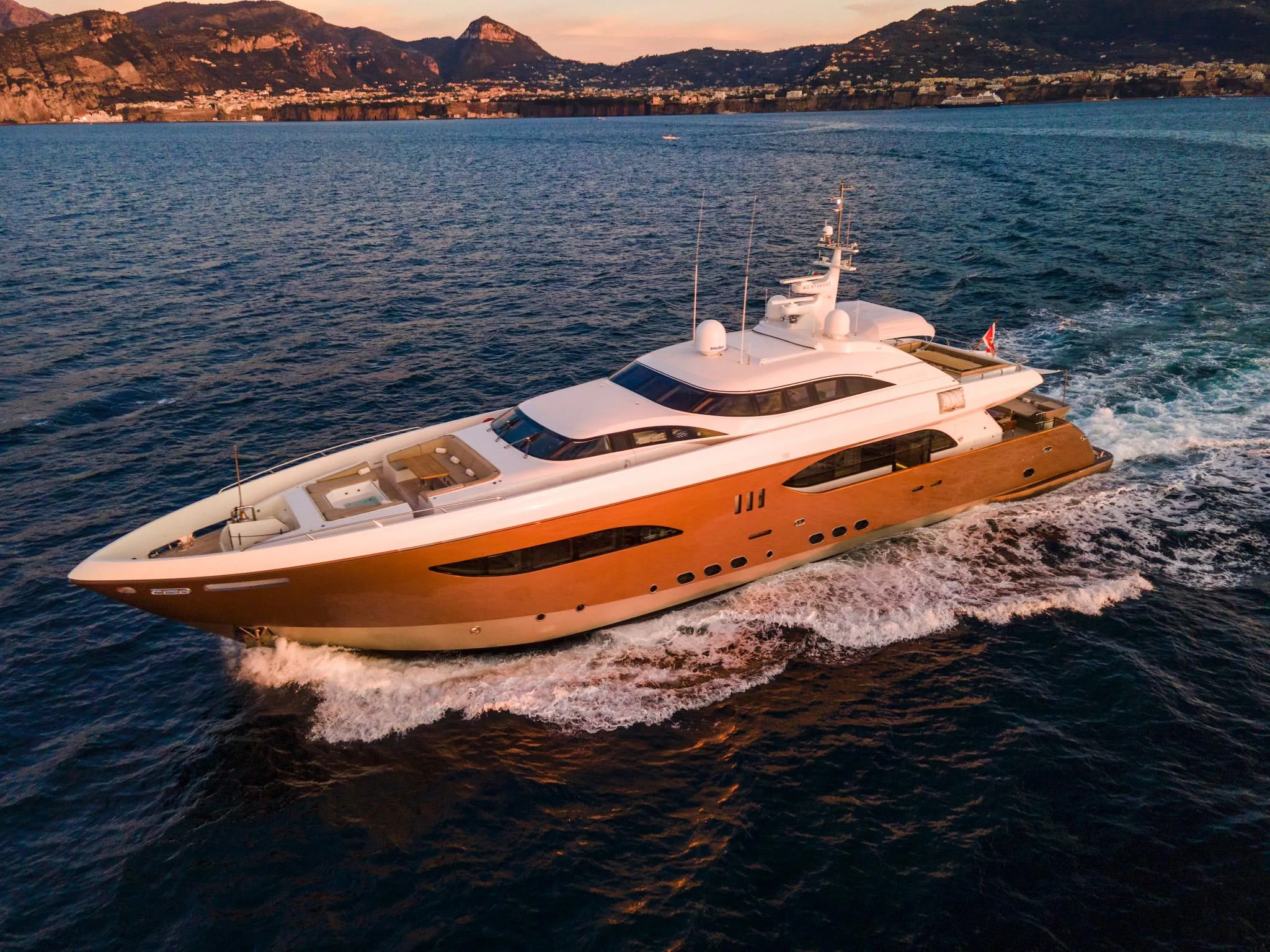 Luxurious custom yacht cruising on the ocean at sunset, 2008 model.