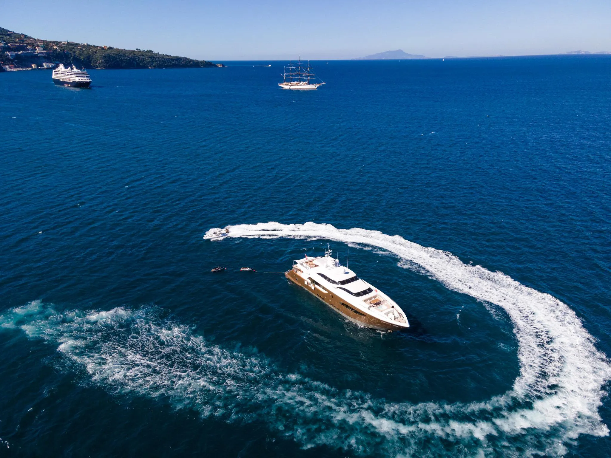 Aerial view of a luxury yacht making a circular wake in the ocean, 2008.