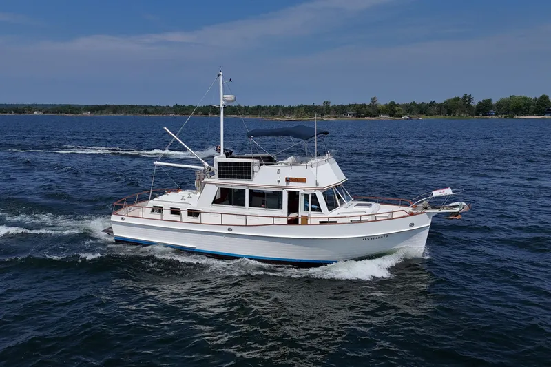  Yacht Photos Pics 1990 Grand Banks 42 Classic yacht cruising on open water under clear skies.