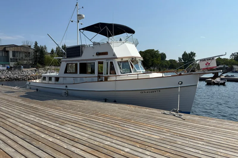  Yacht Photos Pics 1990 Grand Banks 42 Classic yacht docked, for sale sign visible.