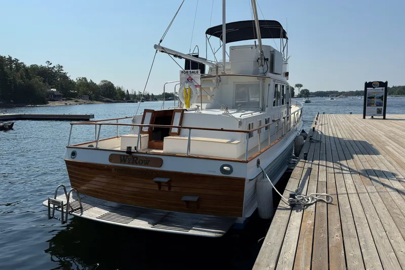  Yacht Photos Pics 1990 Grand Banks 42 Classic yacht docked, for sale sign visible, sunny day on the water.