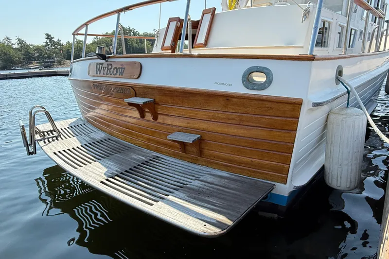  Yacht Photos Pics Stern view of 1990 Grand Banks 42 Classic yacht docked on calm water.