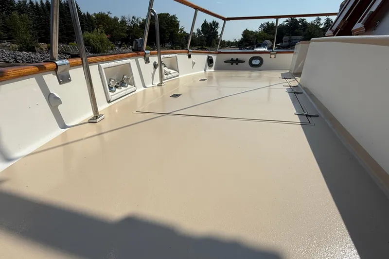  Yacht Photos Pics Deck of 1990 Grand Banks 42 Classic yacht, featuring clean, polished surface and wooden railings.