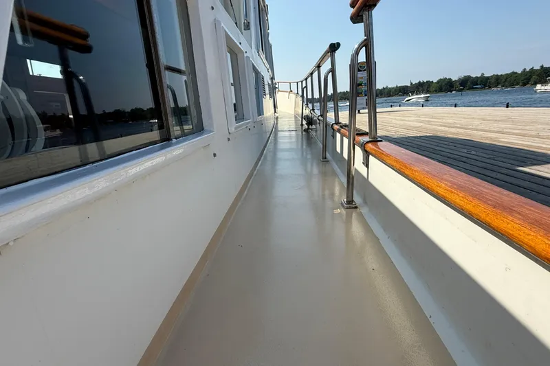  Yacht Photos Pics Side deck view of a 1990 Grand Banks 42 Classic yacht by the water.