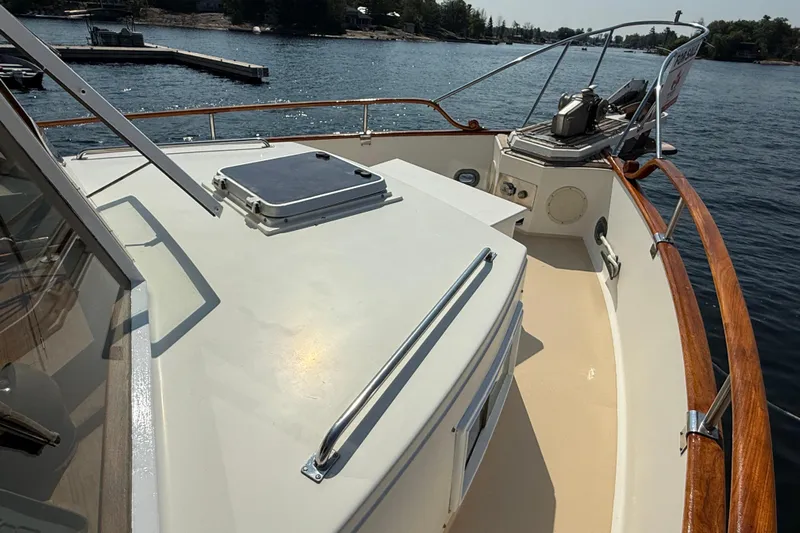  Yacht Photos Pics 1990 Grand Banks 42 Classic yacht deck with wooden railings on a sunny day.