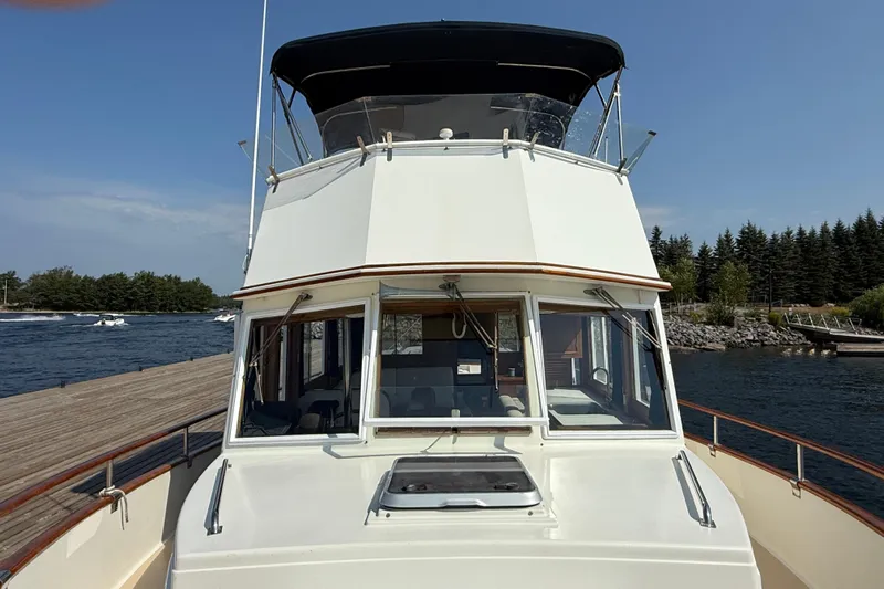  Yacht Photos Pics 1990 Grand Banks 42 Classic yacht docked by a scenic waterfront.