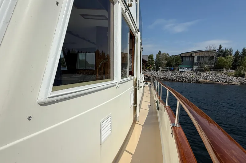  Yacht Photos Pics 1990 Grand Banks 42 Classic yacht docked by a scenic waterfront.