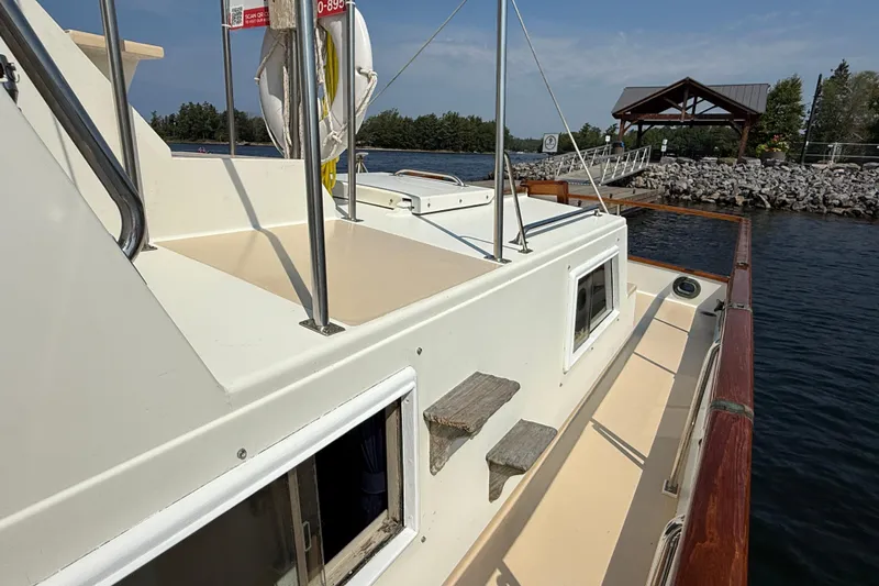  Yacht Photos Pics 1990 Grand Banks 42 Classic yacht docked by a scenic waterfront.