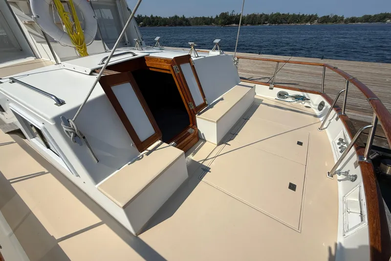  Yacht Photos Pics 1990 Grand Banks 42 Classic yacht deck with open cabin doors, docked by the water.