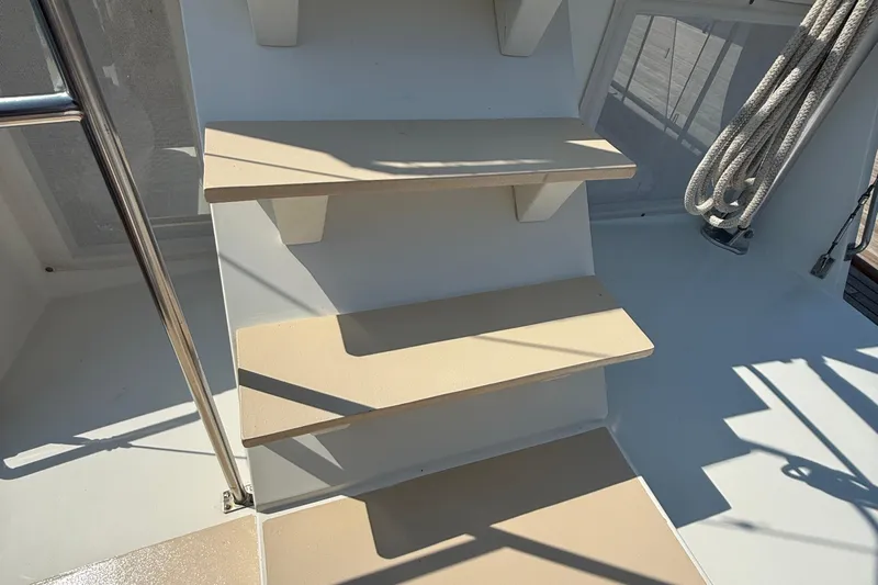  Yacht Photos Pics Staircase on 1990 Grand Banks 42 Classic yacht with metal railing and coiled rope.